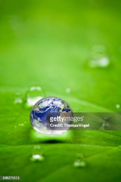 planet earth waterdrop. environment globe water leaf nature world - water globe stock pictures, royalty-free photos & images