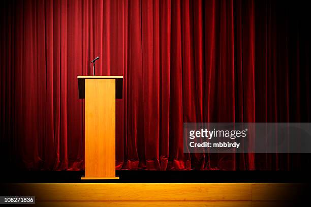 podium on empty stage - lectern stock pictures, royalty-free photos & images
