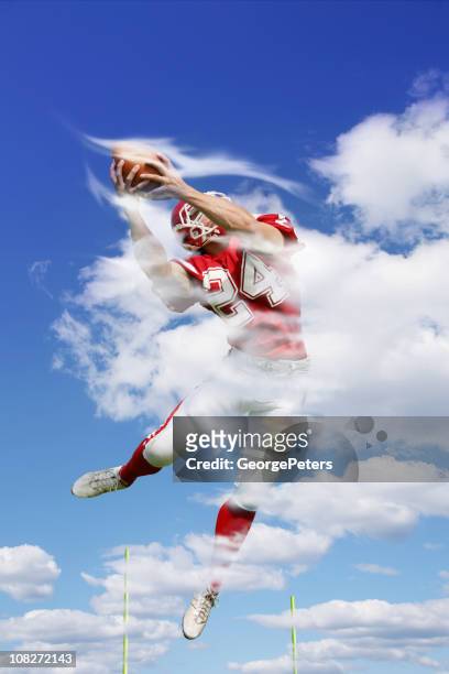 football player making fantastic touchdown catch - touchdown catch stock pictures, royalty-free photos & images