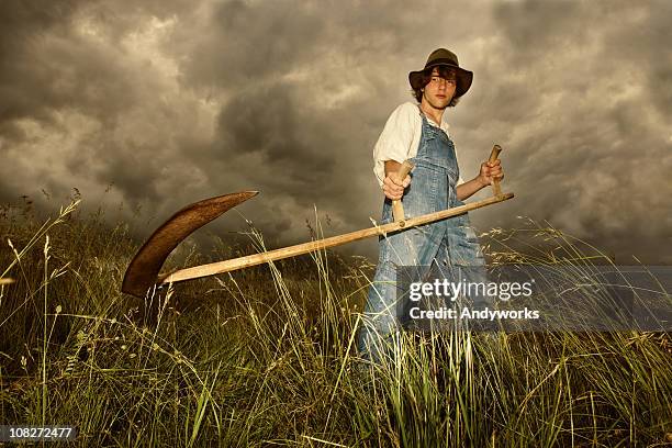 young farmer at work - sickle stock pictures, royalty-free photos & images