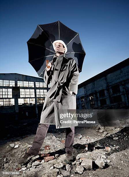 vintage businessman with an umbrella - broken umbrella stockfoto's en -beelden