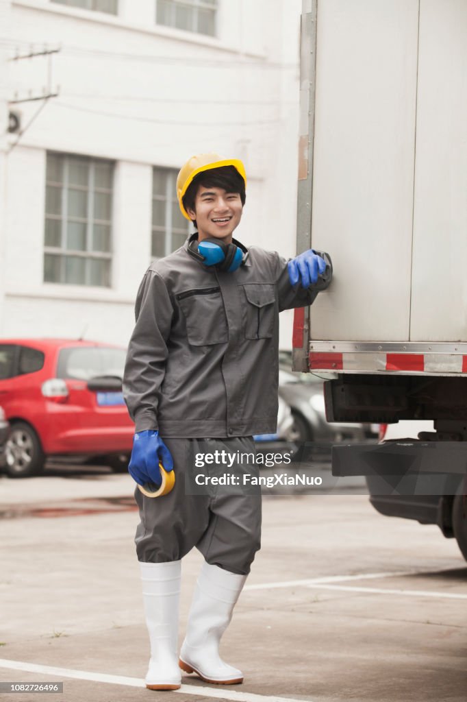 Chinese worker standing outdoors