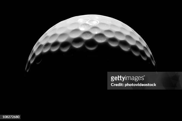 close-up of golf ball on black background, low key - golf ball stock pictures, royalty-free photos & images