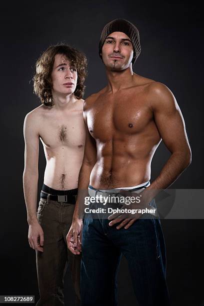 sad shirtless young man looking at muscular male - buff headwear stock pictures, royalty-free photos & images