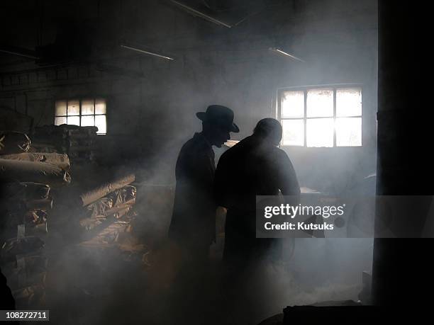 silhouette of men in smoke - gang crime stock pictures, royalty-free photos & images