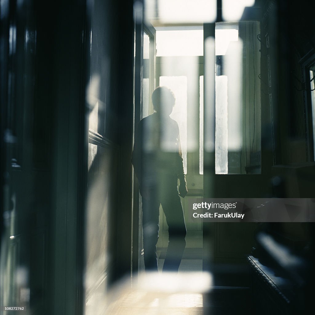 Man Standing between Doors