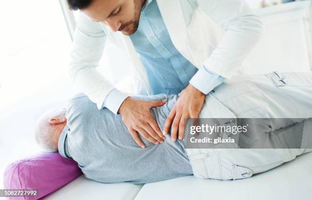 lower back pain medical examination. - lower back pain stock pictures, royalty-free photos & images