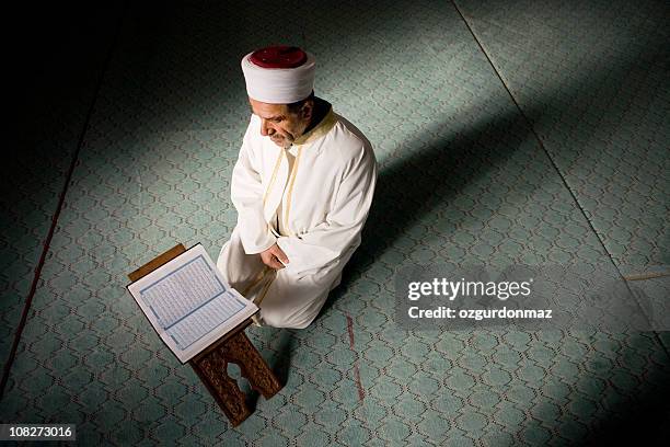 imam reading holly quran - koran stock pictures, royalty-free photos & images