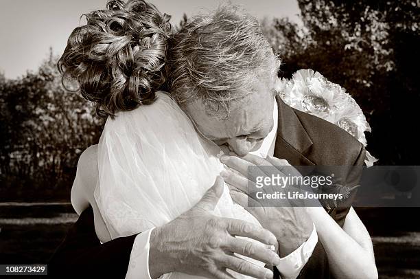 emotional father of the bride giving his daughter a hug - bride father stock pictures, royalty-free photos & images