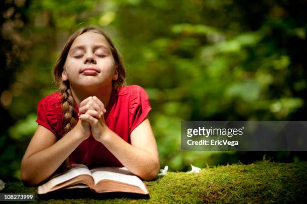 young girl praying on a tree outdoors - child praying stock pictures, royalty-free photos & images