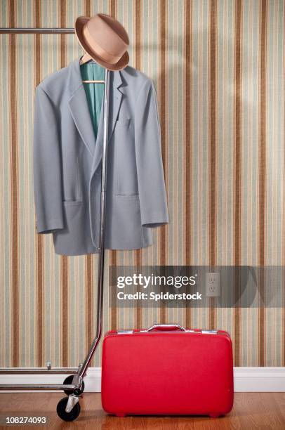 red suitcase with coat and hat - suit rack stock pictures, royalty-free photos & images