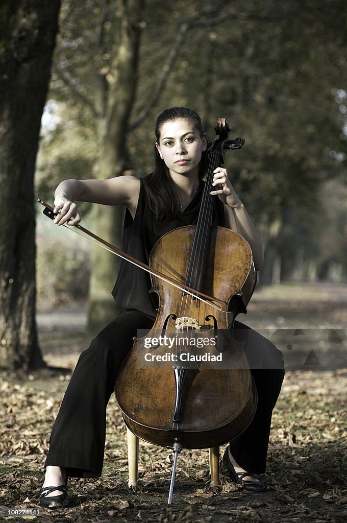Woman with cello outdoors