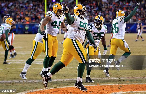 Raji of the Green Bay Packers reacts with teammates after scoring on a 18-yard interception return for a touchdown in the fourth quarter against the...