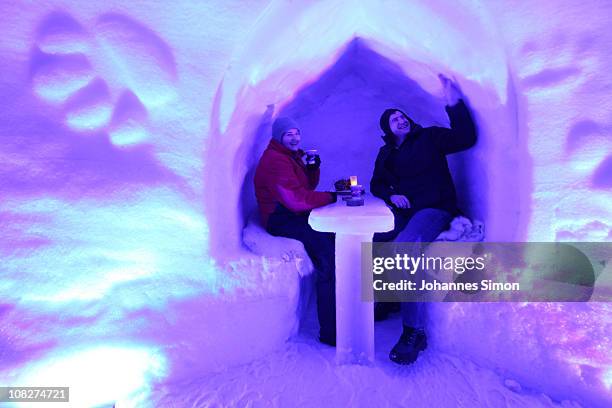 Guests attend the Alpeniglu Hotel ice bar at Hochbrixen on January 23, 2011 in Brixen im Thale, Austria. The hotel is built completely of snow and...