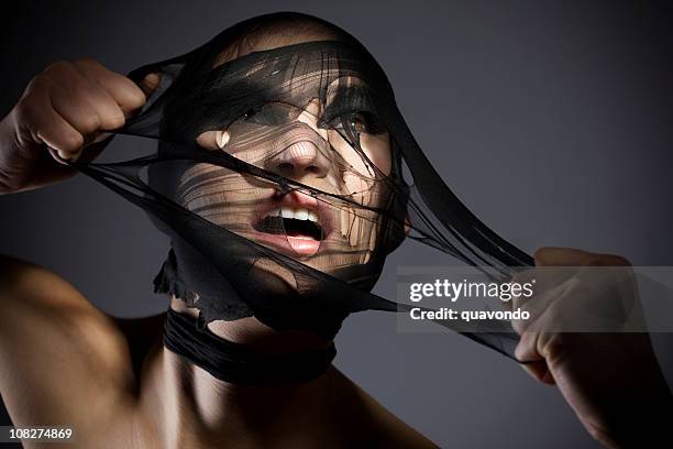 beautiful young woman tearing off mask, copy space - women wearing black stockings stock pictures, royalty-free photos & images