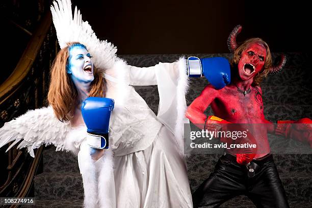 the fight between good and evil - good evil stock pictures, royalty-free photos & images