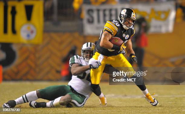 Pittsburgh Steelers wide receiver Hines Ward makes a first down catch and is brought down by New York Jets linebacker David Harris on the opening...