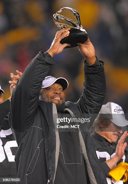 Steelers coach Mike Tomlin raises the AFC championship trophy following Pittsburgh's 24-19 win over the New York Jets in the AFC Championship game on...