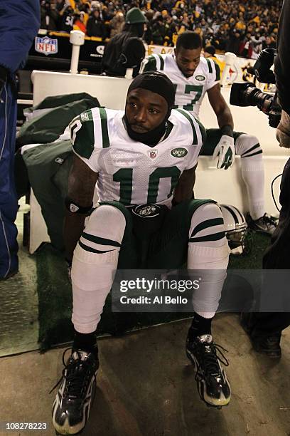 Santonio Holmes of the New York Jets sits dejected after being defeated 24 to 19 by the Pittsburgh Steelers in the 2011 AFC Championship game at...