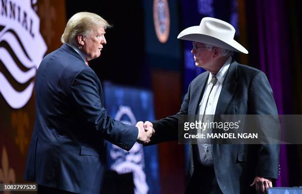 President Donald Trump shakes hands with Arizona farmer Jim Chilton during the annual American Farm Bureau Federation convention in the Ernest N....