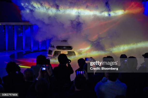 Attendees take photographs as the Subaru Corp. STI S209 vehicle is revealed during the 2019 North American International Auto Show in Detroit,...