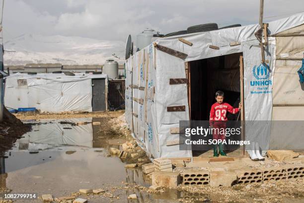 Young boy watches out of his makeshift accommodation after storm Norma passed through causing heavy flooding and damage displacing many refugees....
