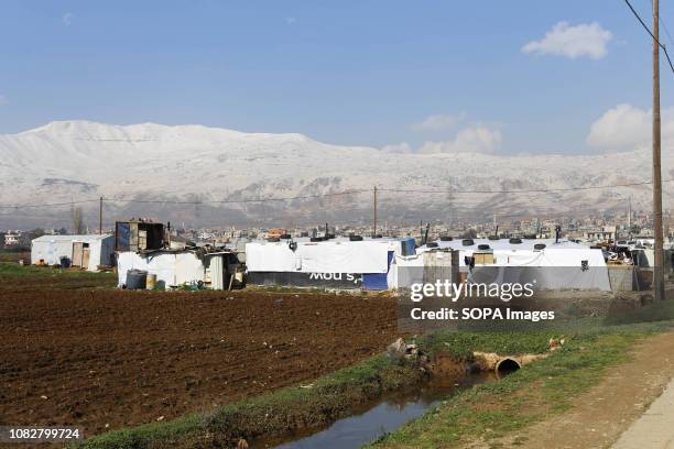 The border of Syria lies behind this mountain range. An informal refugee settlement sits on agricultural land. Storm Norma affected thousands of...