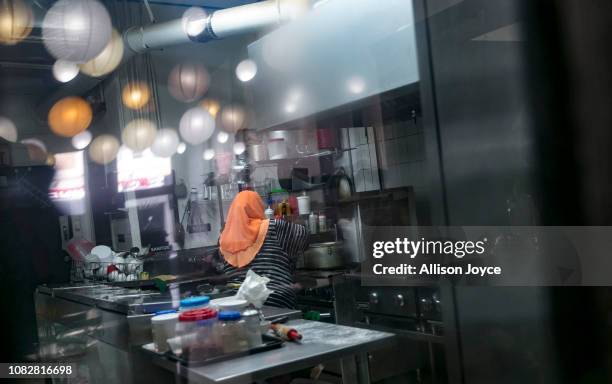 Rohingya refugee works at the Tea Leaf Garden restaurant on January 11, 2019 in Chicago, Illinois. In 2018 Rohingya refugee Nasimah and her friend...