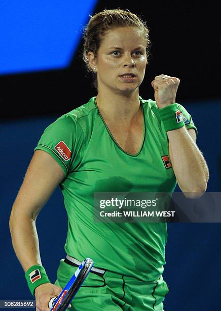 Kim Clijsters of Belgium gestures as she celebrates winning the first set during her fourth round women's singles match against Ekaterina Makarova of...