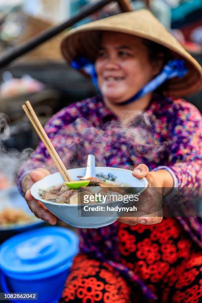 vietnamese woman selling famous noodle soup, floating market, mekong river delta, vietnam - vietnam market stock pictures, royalty-free photos & images