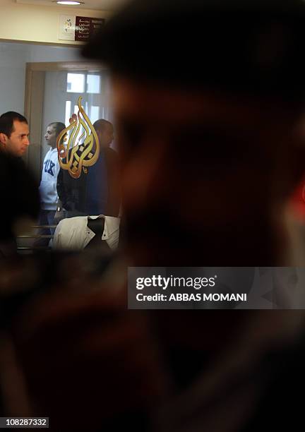 Palestinian security forces stand guard inside the offices of the pan-Arab news channel Al-Jazeera in the West Bank city of Ramallah following an...