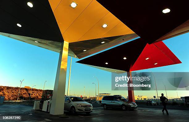 Customers fill their vehicles with fuel at a Repsol YPF SA gas station in Madrid, Spain, on Monday, Jan. 24, 2011. Repsol YPF SA, Spain's largest oil...