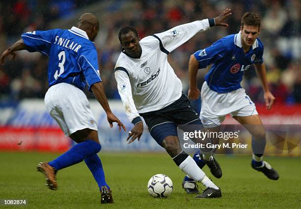 Michael Ricketts of Bolton Wanderers takes the ball past Frank Sinclair and Lee Marshall of Leicester City during the FA Barclaycard Premiership...