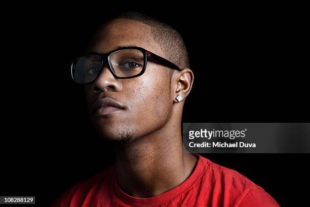 portrait of a young man on a black background - earrings stock pictures, royalty-free photos & images