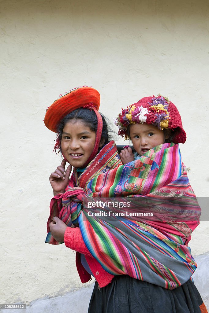 Peru, Patacancha, Indian girl carrying baby