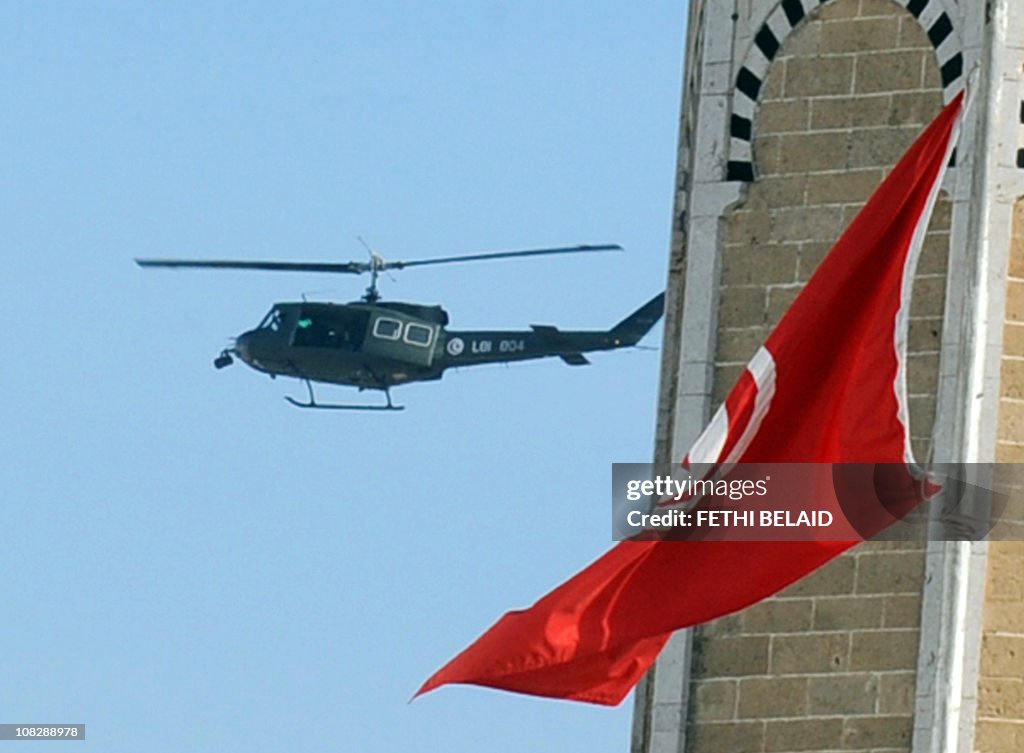 A Tunisian military helicopter flies ove