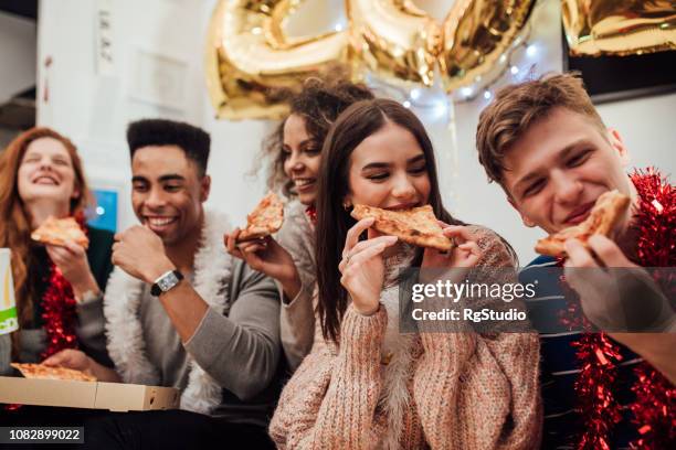 smiling people eating pizza - happy new year 2018 stock pictures, royalty-free photos & images