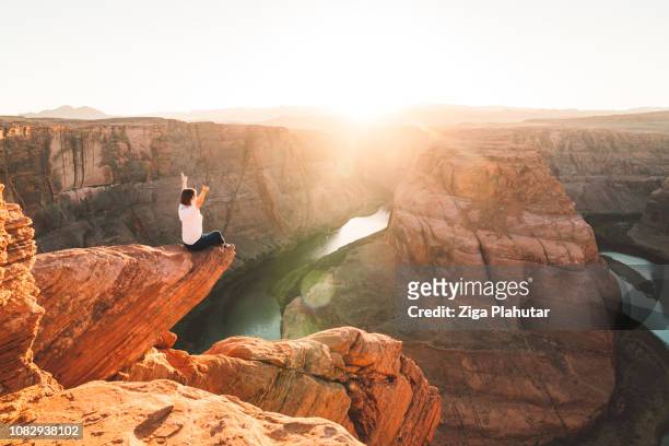 woman sitting on the edge - grand canyon national park stock pictures, royalty-free photos & images