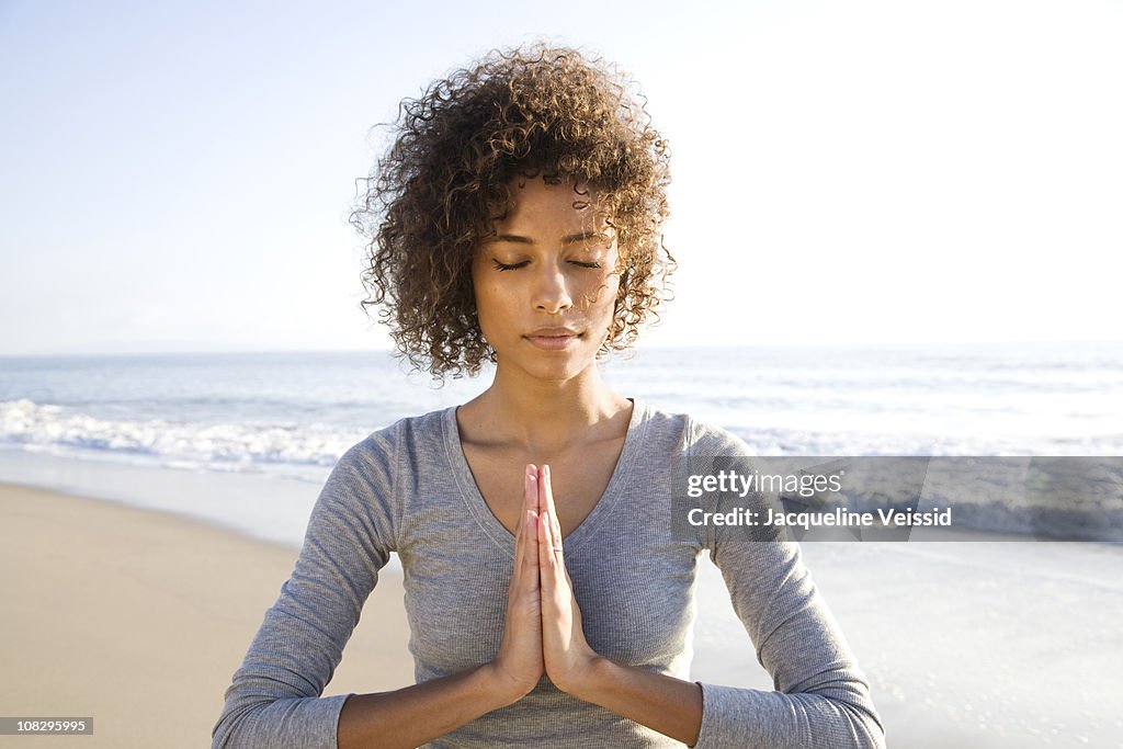 Woman doing yoga on beach