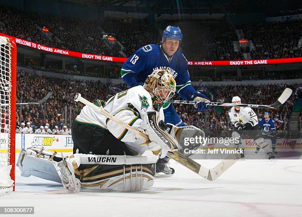 Raffi Torres of the Vancouver Canucks looks on as Kari Lehtonen of the Dallas Stars makes a save during their game at Rogers Arena on January 24,...