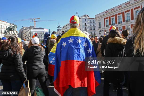 Protester seen wrapping himself with a Venezuelan flag during the protest against Nicolas Maduro. The Venezuelans community of Madrid took the street...