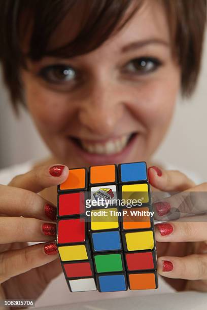 Model, Emily Dixon playing wth the classic Rubiks Cube at the Toy Fair 2011 at Olympia Exhibition Centre on January 25, 2011 in London, England.