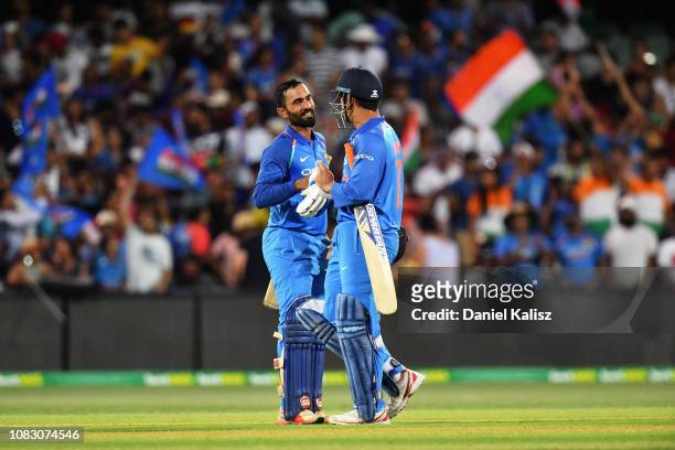 Dinesh Karthik of India celebrates with MS Dhoni of India after deferating Australia during game two of the One Day International series between...