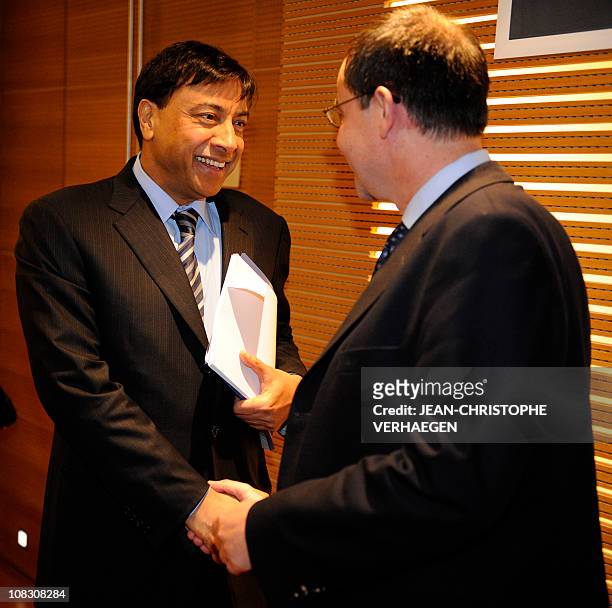 The chairman of the board of directors and chief executive officer of the world's largest steel company, ArcelorMittal, Lakshmi Mittal , shakes hand...