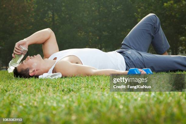 chinese man resting after exercise in park - live finale stock pictures, royalty-free photos & images