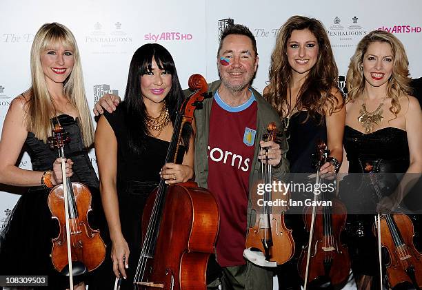 Musician Nigel Kennedy poses in the press room with the band Bond at the South Bank Sky Arts Awards at The Dorchester on January 25, 2011 in London,...