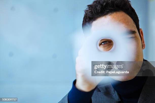 architect looking through a roll of blueprints - looking through an object stock pictures, royalty-free photos & images