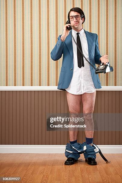 nerdy businessman speaking on vintage telephone - trousers down stock pictures, royalty-free photos & images