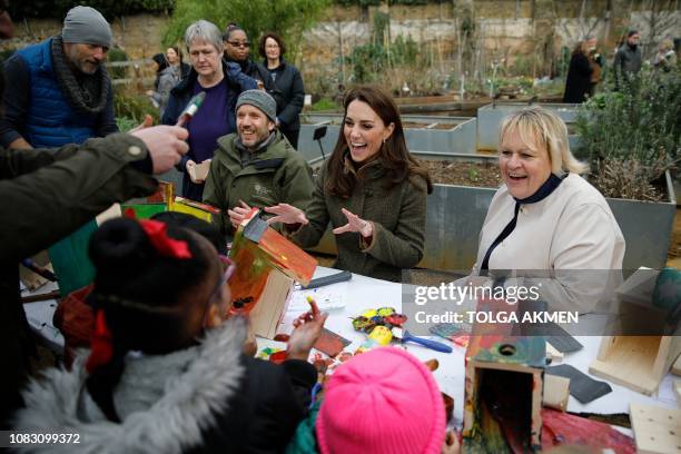 Britain's Catherine, Duchess of Cambridge helps make bird boxes as she visits the Islington community garden in north London on January 15, 2019.