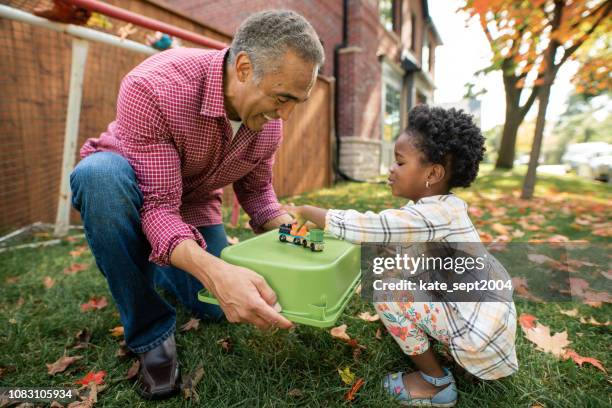 grandparents, parent and granddaughter together - canadian senior men stock pictures, royalty-free photos & images